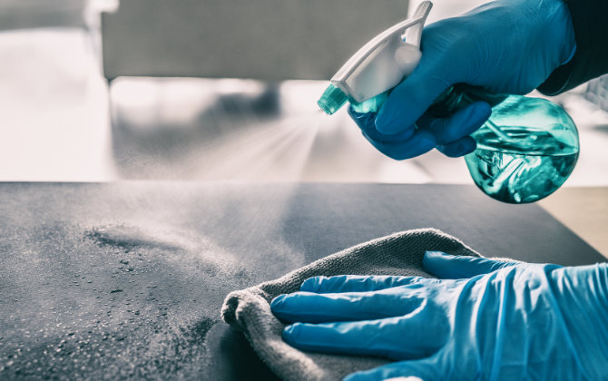 a person sterilizing surfaces between appointments at Buford Family Dental